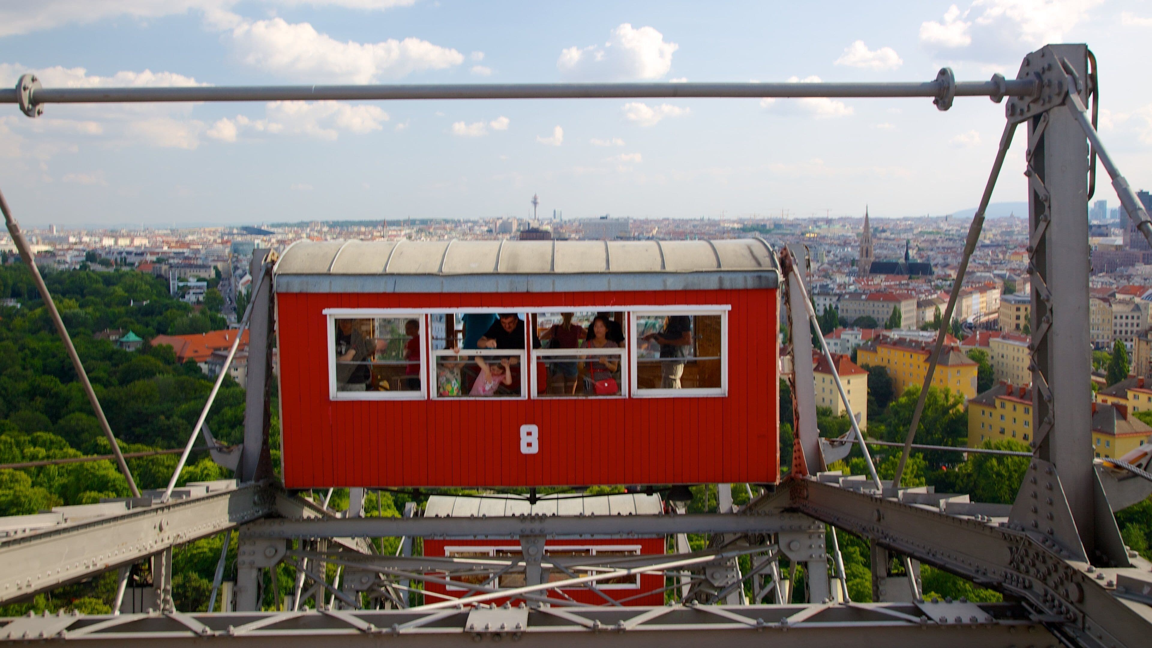 Wiener Prater showing rides and a city as well as a family