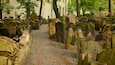 Old Jewish Cemetery in Prague showcases ancient gravestones amidst serene greenery and historical significance