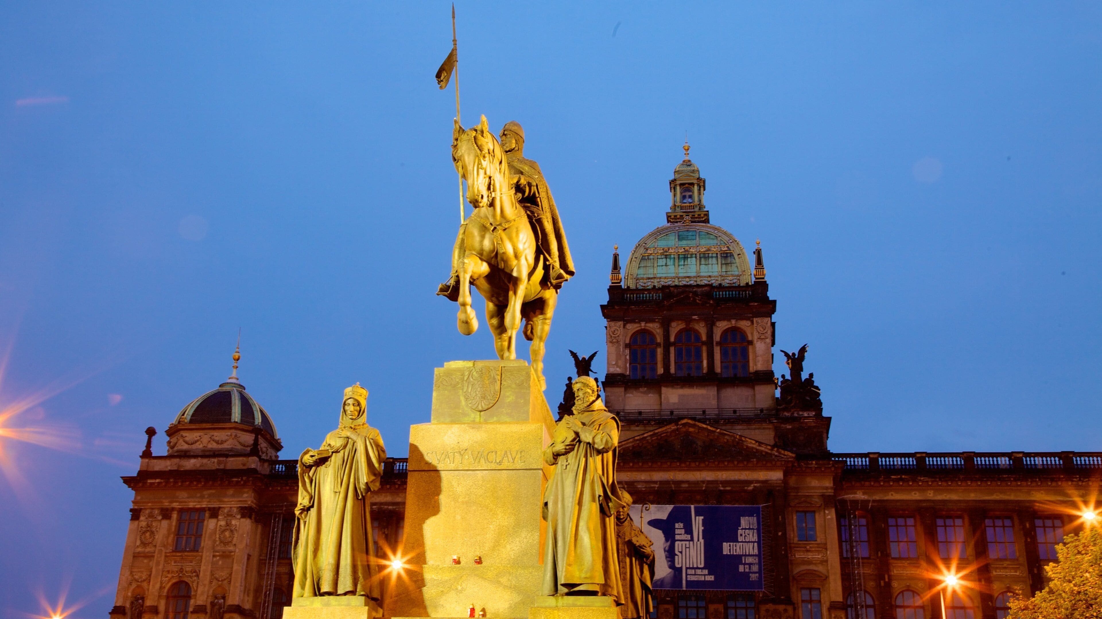 Wenceslas Square featuring a statue or sculpture, night scenes and heritage architecture