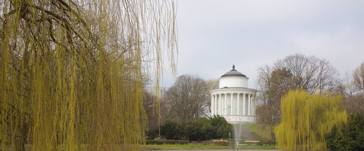 Saxon Gardens featuring a pond and a fountain