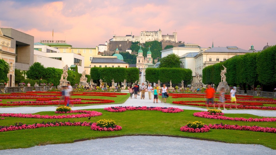 Mirabell Palace featuring a garden, flowers and a city