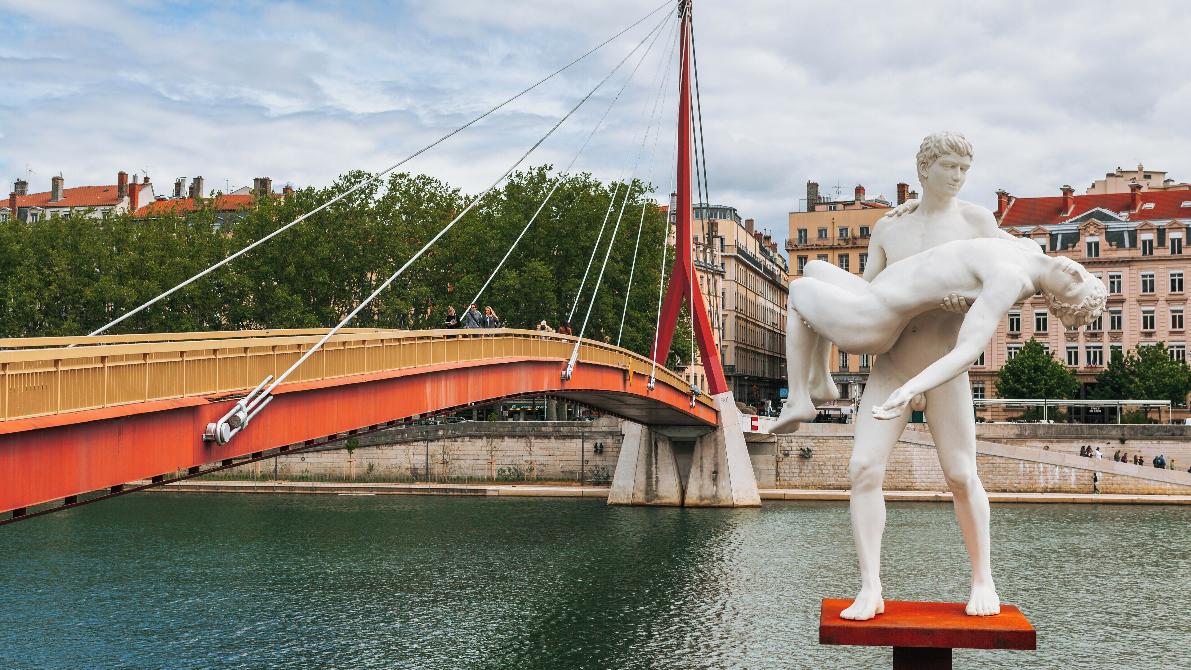 Visit to Bellecour Square in Lyon reveals a striking bridge and a captivating sculpture, illustrating the city's blend of art and modern architecture