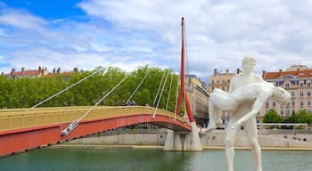 Bellecour Square showing a statue or sculpture, a bridge and a river or creek