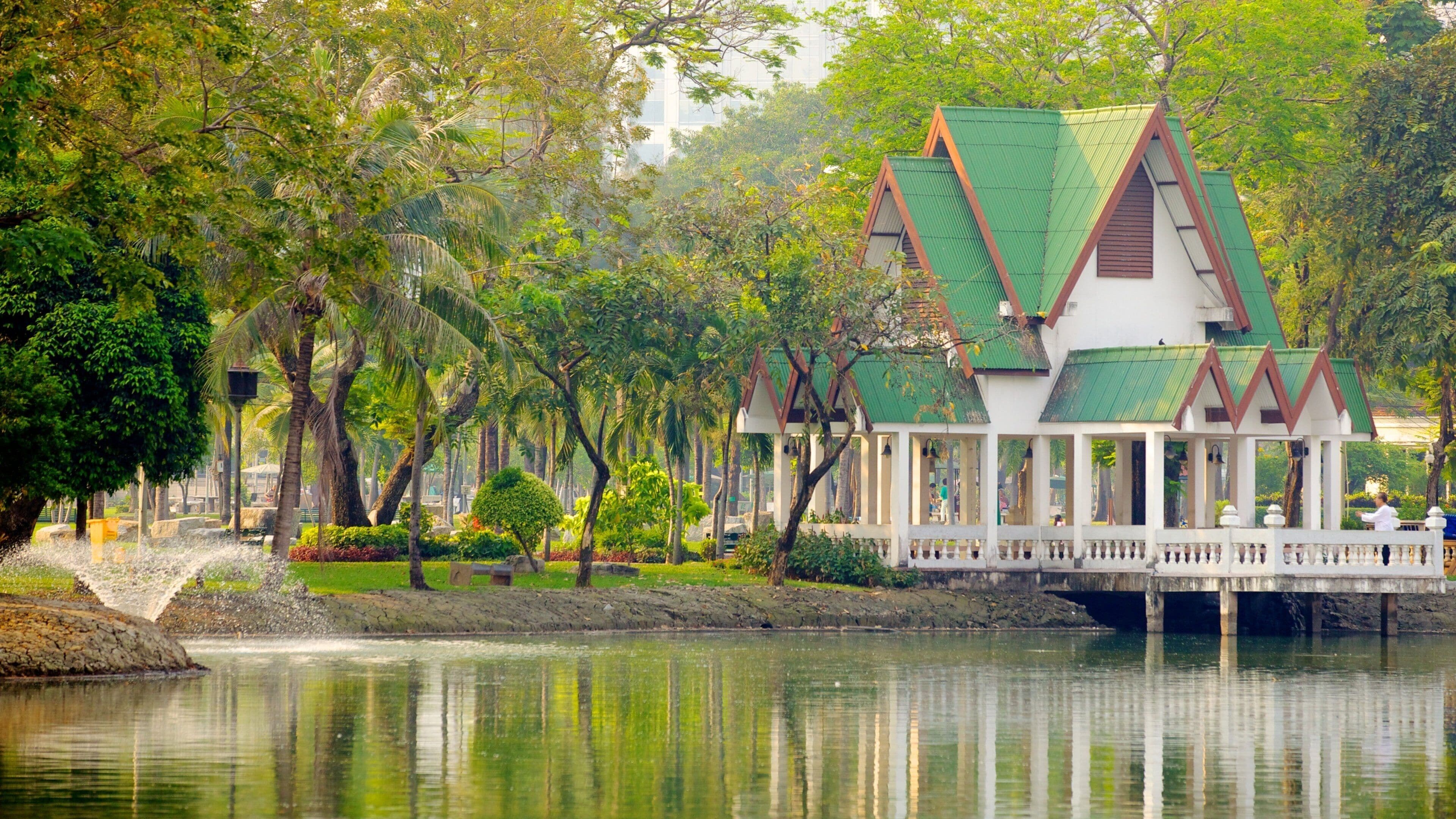 Lumpini Park which includes a house, a lake or waterhole and landscape views