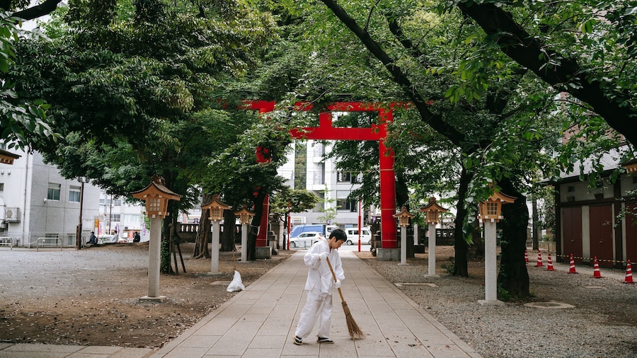 Shinjuku Gyoen National Garden featuring a temple or place of worship as well as an individual male