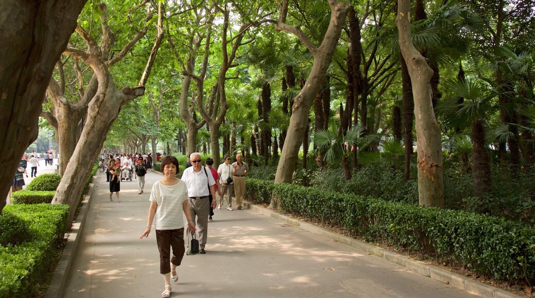 Fuxing Park featuring a garden as well as a small group of people