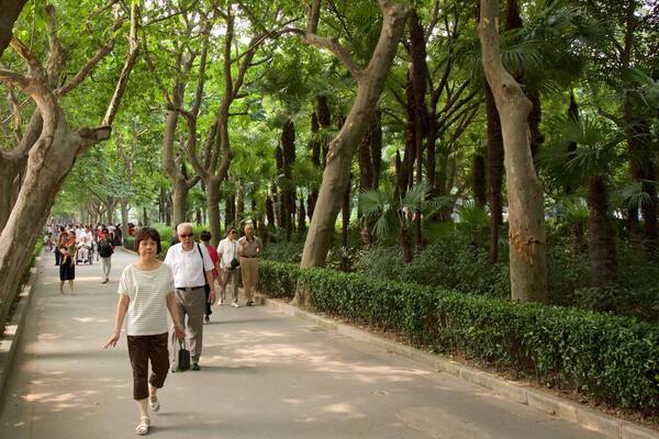 Fuxing Park featuring a garden as well as a small group of people