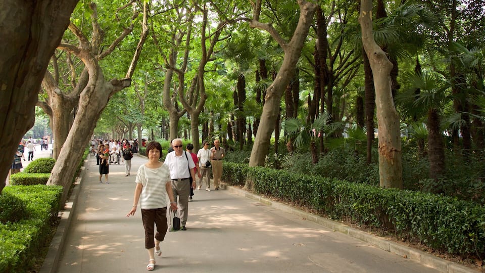 Fuxing Park featuring a garden as well as a small group of people