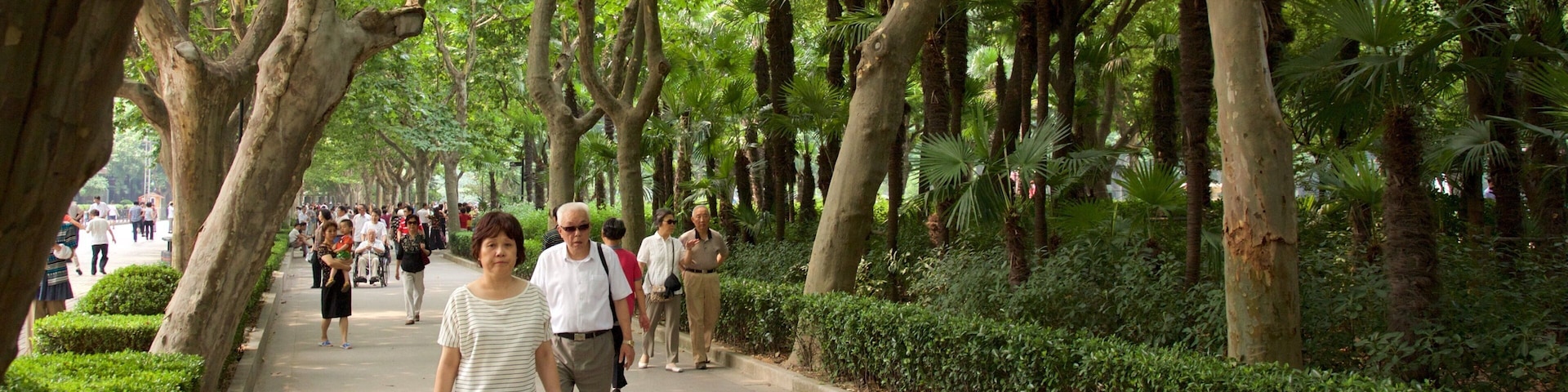 Fuxing Park featuring a garden as well as a small group of people