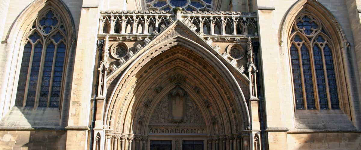 A historic cathedral with intricate Gothic architecture, large rose window, and pointed arches.