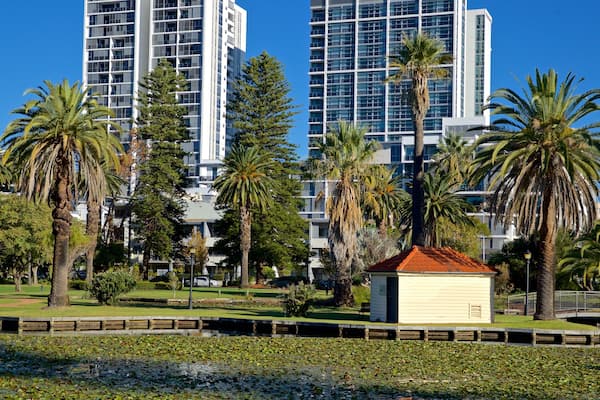 Queens Gardens which includes a park, a city and a pond