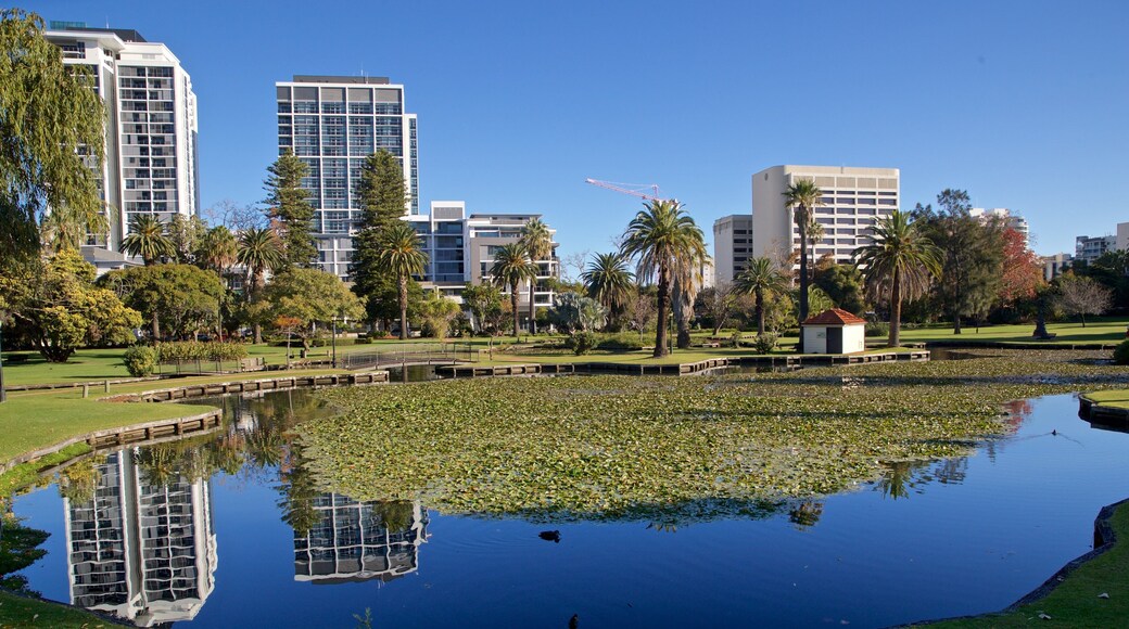 Queens Gardens featuring a pond and a park