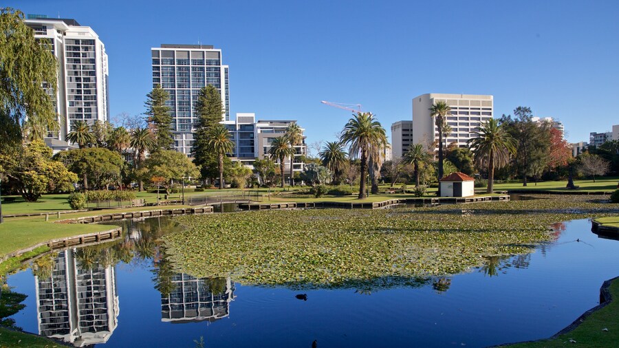 Queens Gardens featuring a pond and a park