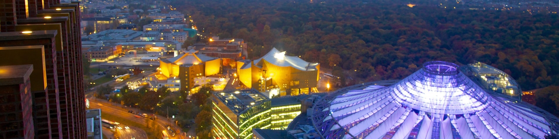 Vibrant evening lights illuminate Potsdamer Platz showcasing modern architecture and urban life in Berlin