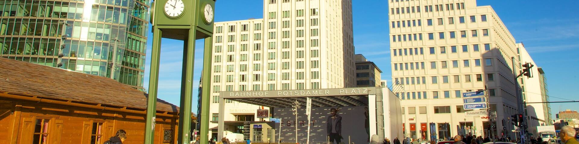 Explore the vibrant Potsdamer Platz with towering buildings and lively atmosphere in Berlin, Germany during a sunny day