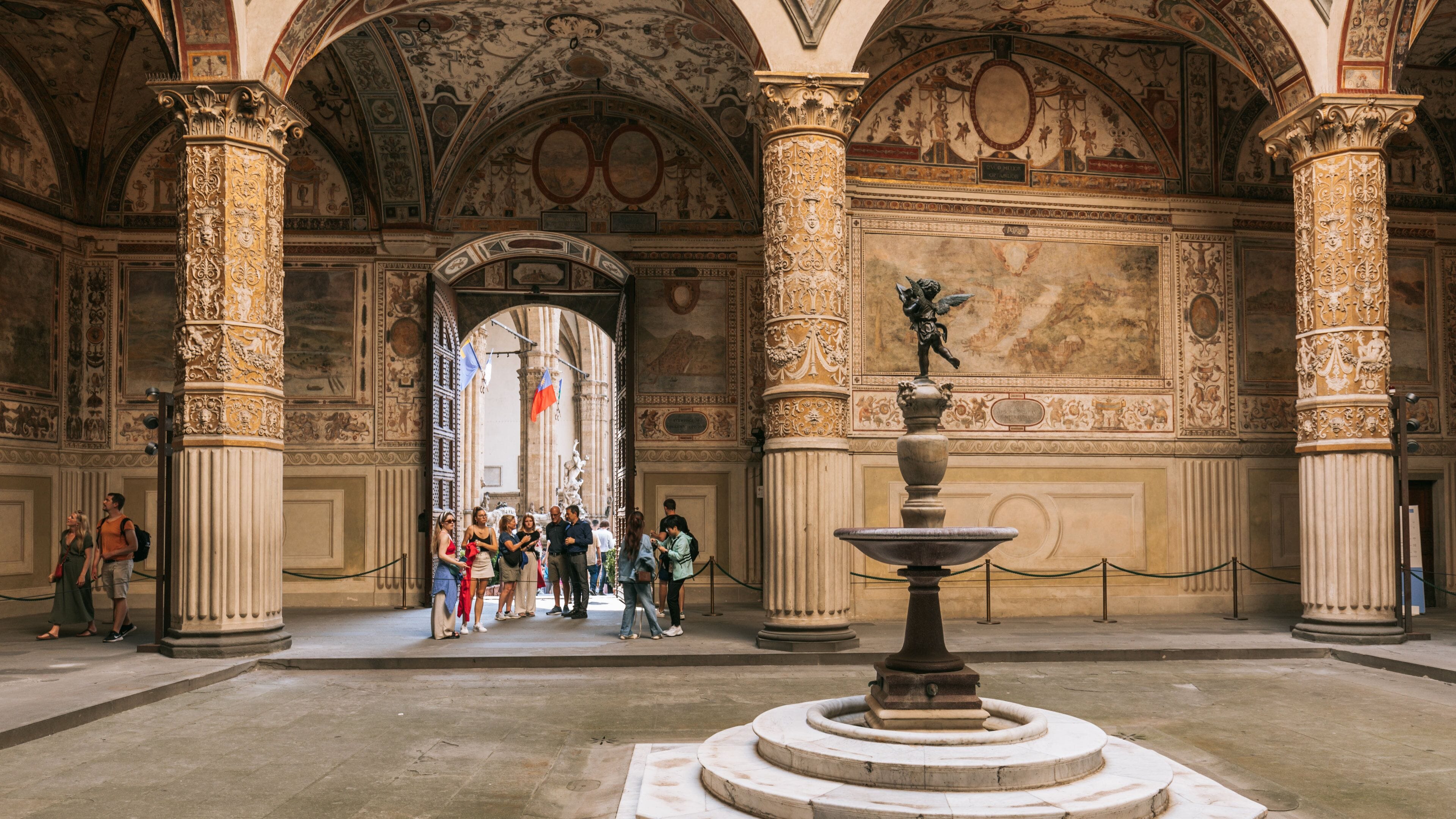 Piazza della Signoria featuring interior views and heritage elements as well as a small group of people