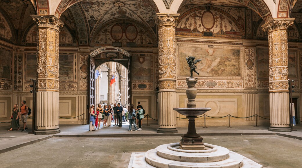 Piazza della Signoria featuring interior views and heritage elements as well as a small group of people