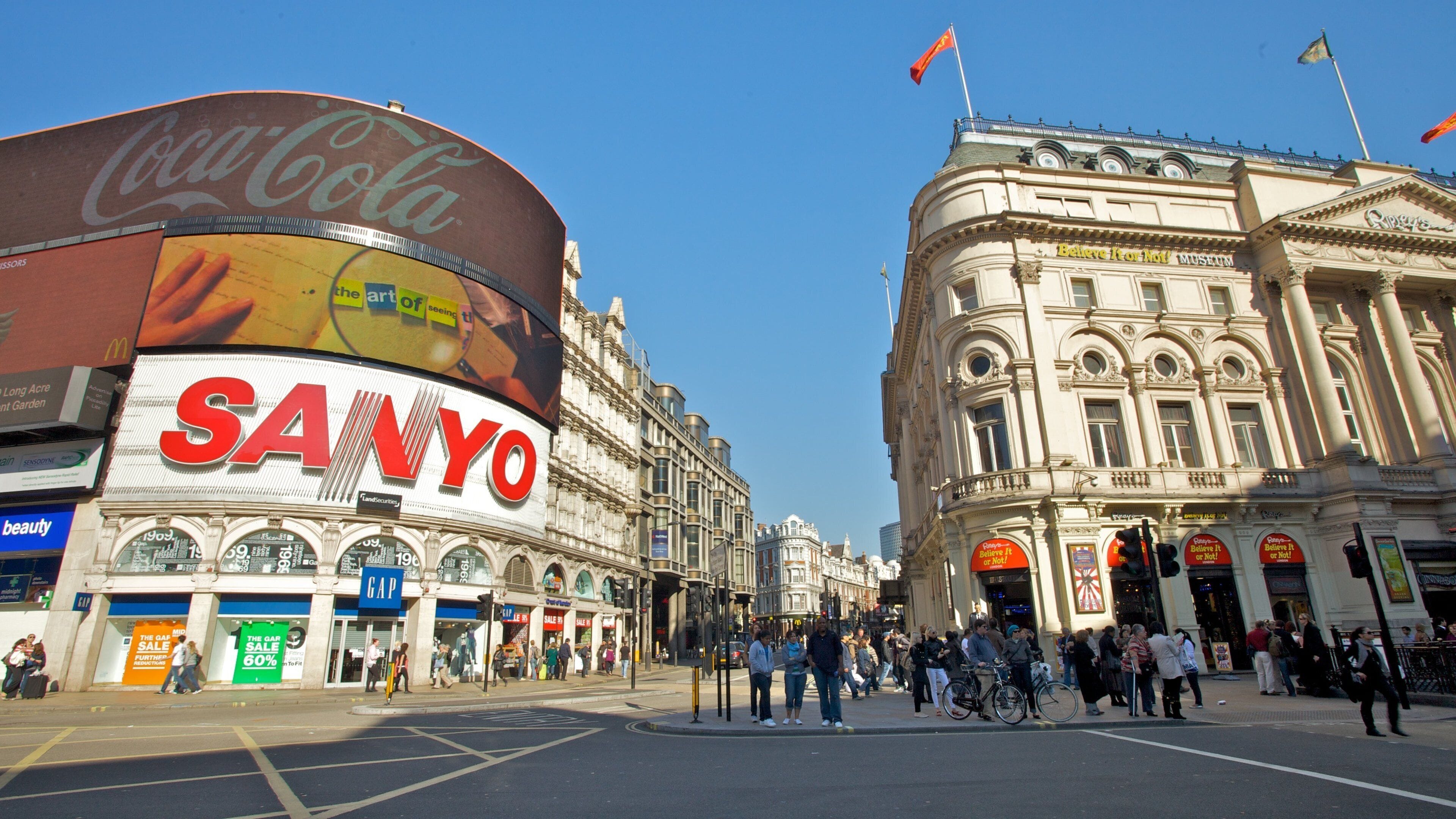 Vibrant atmosphere and bustling crowds at Piccadilly Circus in London during a sunny day