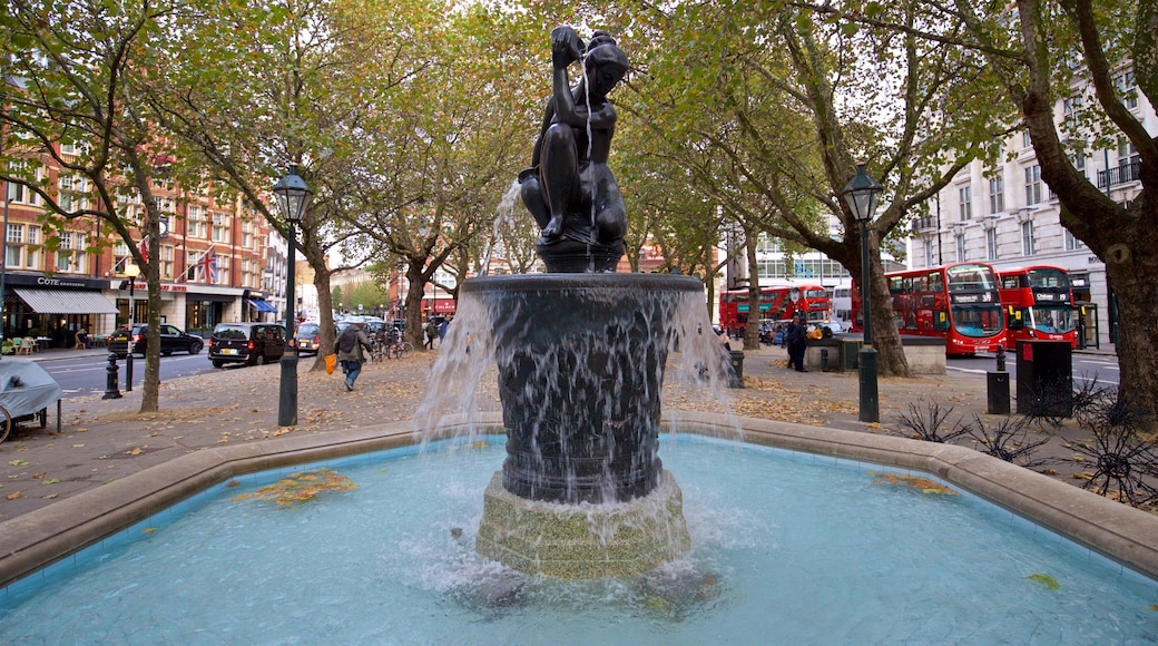 Sloane Square featuring a fountain