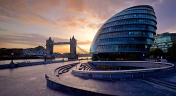 Tower Bridge showing a sunset, modern architecture and a city