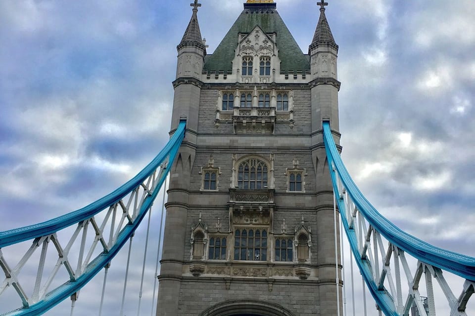 Tower Bridge in London, with cars and pedestrians on the bridge.