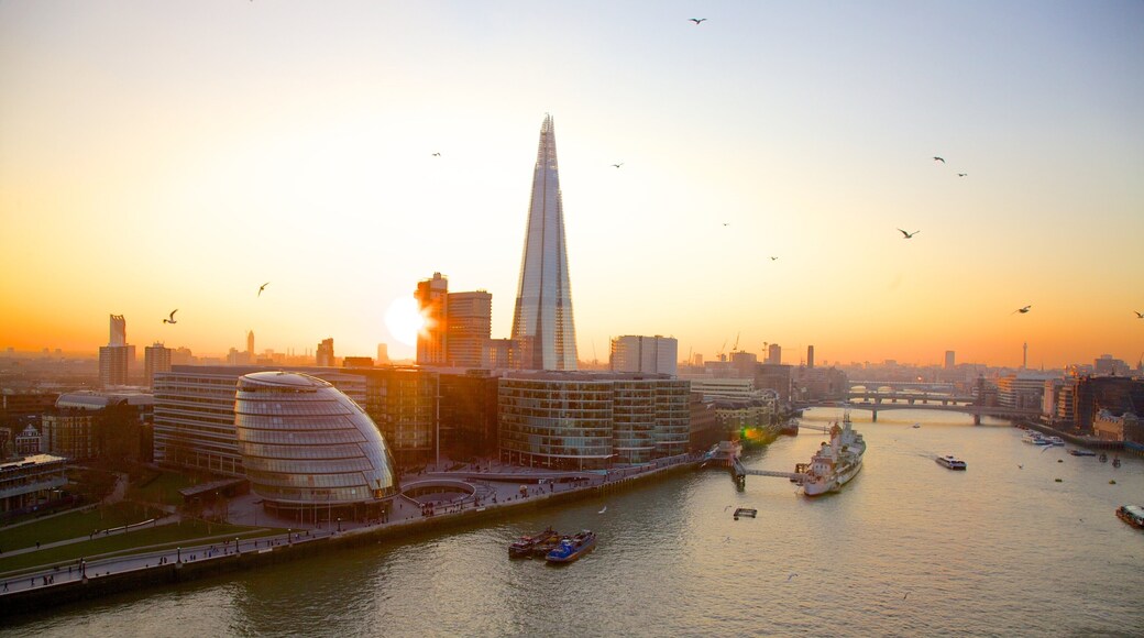 Tower Bridge showing a bay or harbor, a sunset and modern architecture