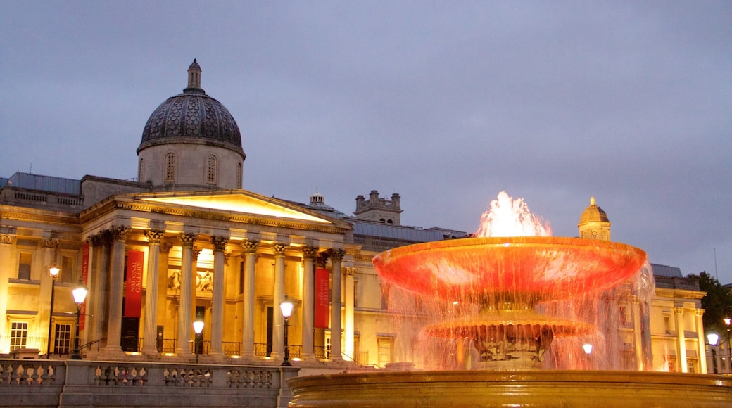 Trafalgar Square which includes a square or plaza, a fountain and night scenes