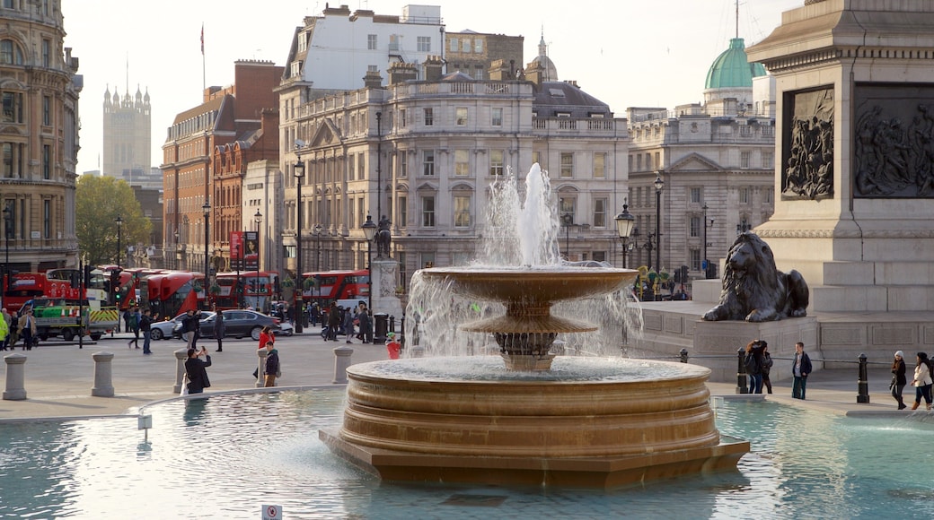 Trafalgar Square featuring a fountain and a city