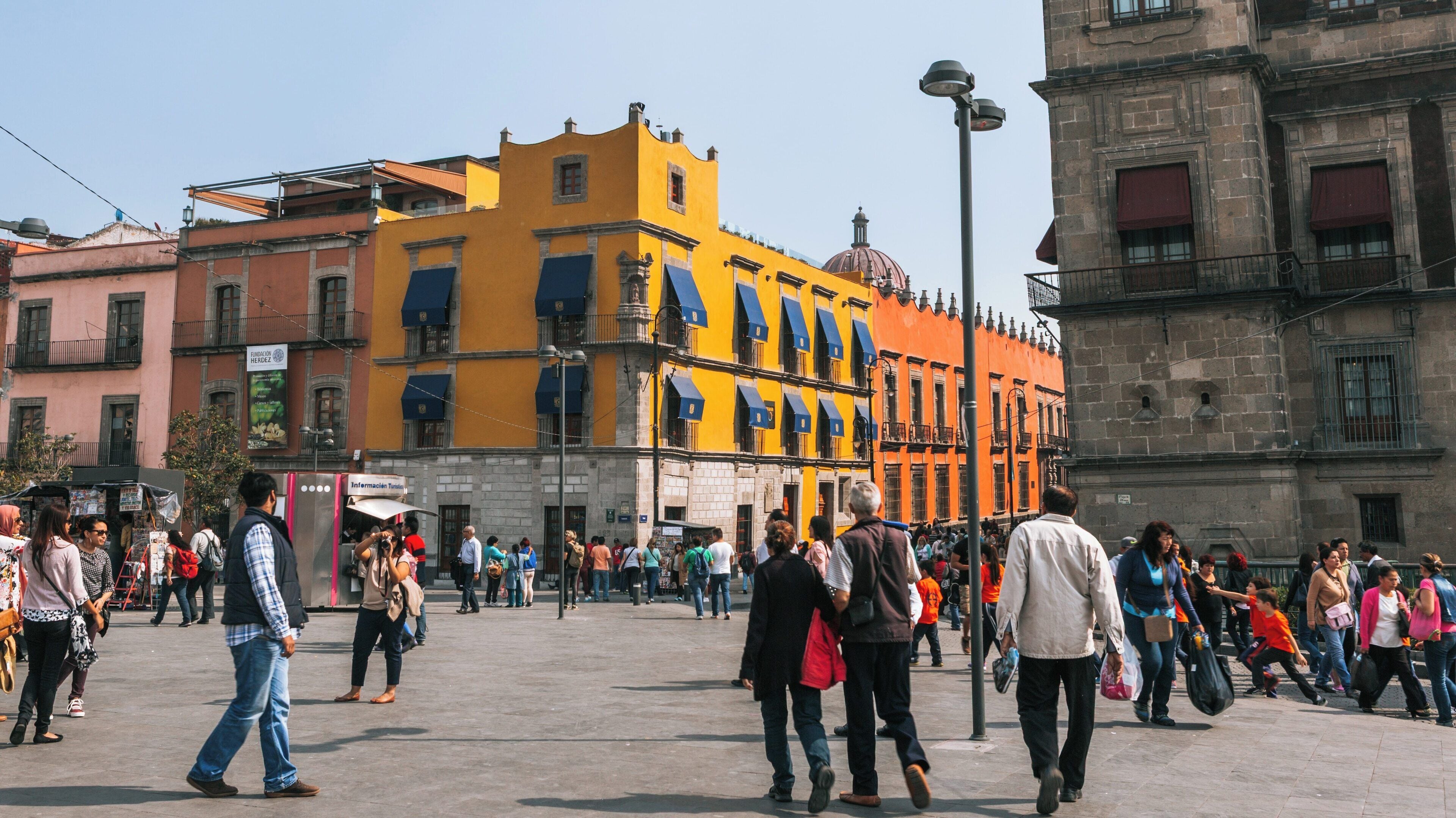 Vibrant crowds gather at Zocalo in Cuauhtemoc, Mexico City under clear skies