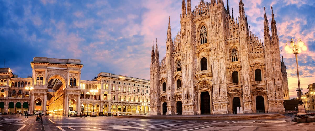 A grand cathedral with intricate Gothic architecture, a bustling square with historic buildings, and a clear sky.