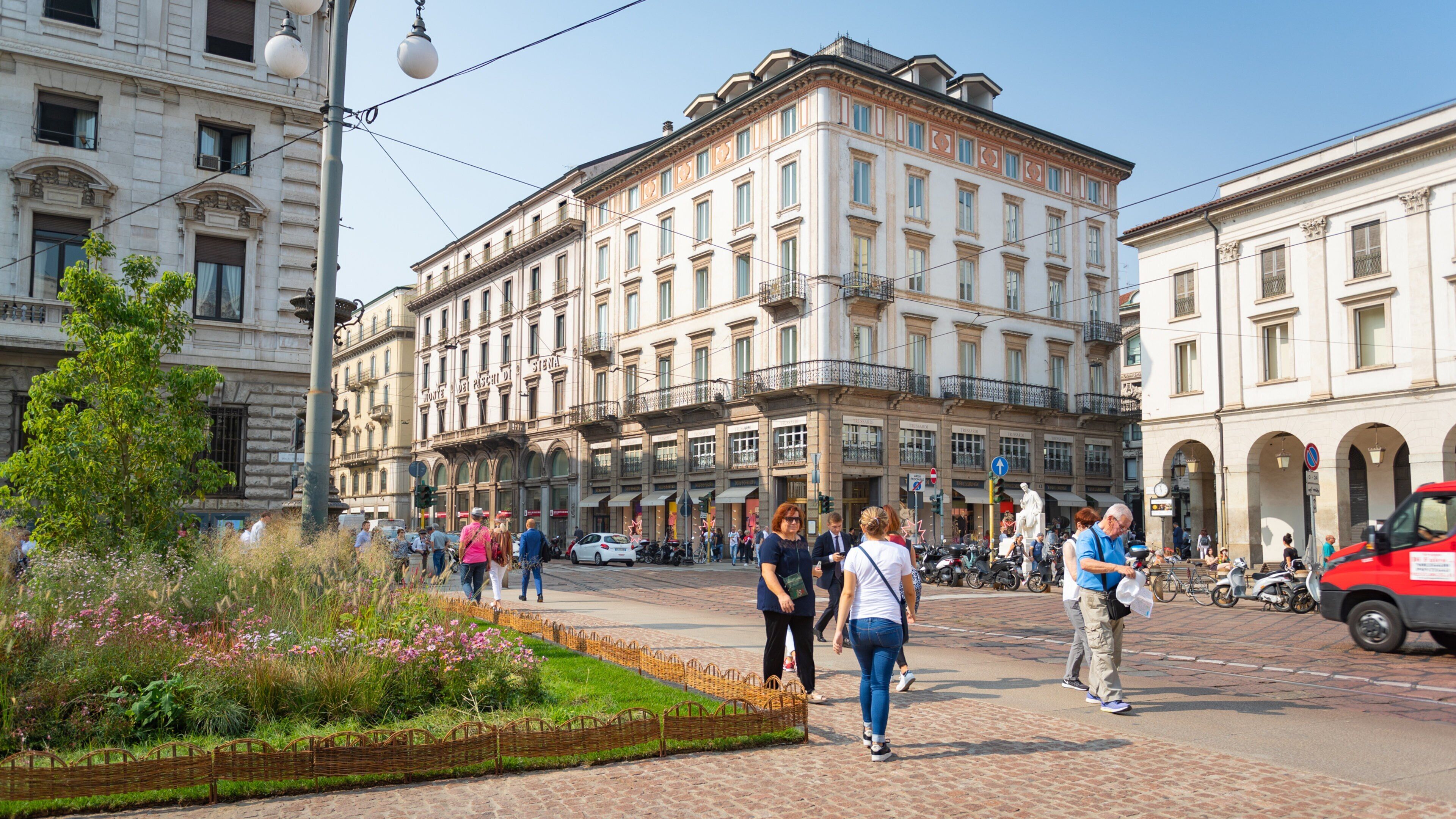 Piazza della Scala featuring wildflowers, a park and street scenes