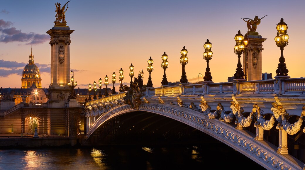 Pont Alexandre III Bridge and illuminated lamp posts at sunset with view of the Invalides. 7th Arrondissement, Paris, France