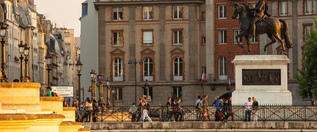 Pont Neuf featuring heritage architecture and a statue or sculpture