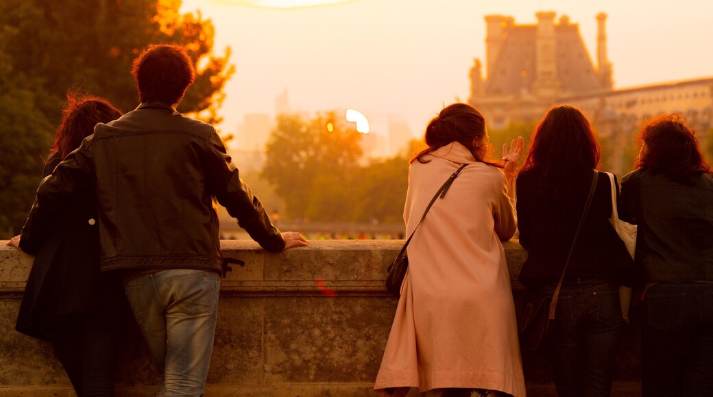 Pont Neuf featuring a sunset as well as a small group of people