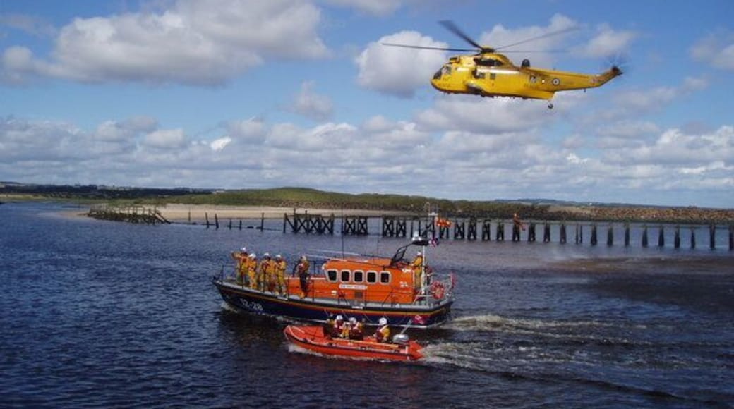 Lifeboat Day, Amble Amble Lifeboat Crew and the helicopter rescue team from RAF Boulmer demonstrate their lifesaving skills. The disused North jetty of Warkworth Harbour is in the background.