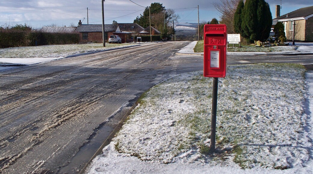 Looking West From near the junction of Rothbury Road into Cheviot Lodge. Villa Lane and West lane cottages can be seen to the left, Simonside under snow in the middle distance and No 1 Cheviot Lodge to the right.