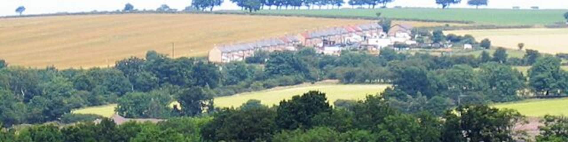 Hazon High Houses. The road in the foreground is the A1. Photograph taken from Newton On The Moor.