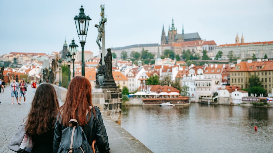 Charles Bridge showing a bay or harbor and a bridge as well as a couple