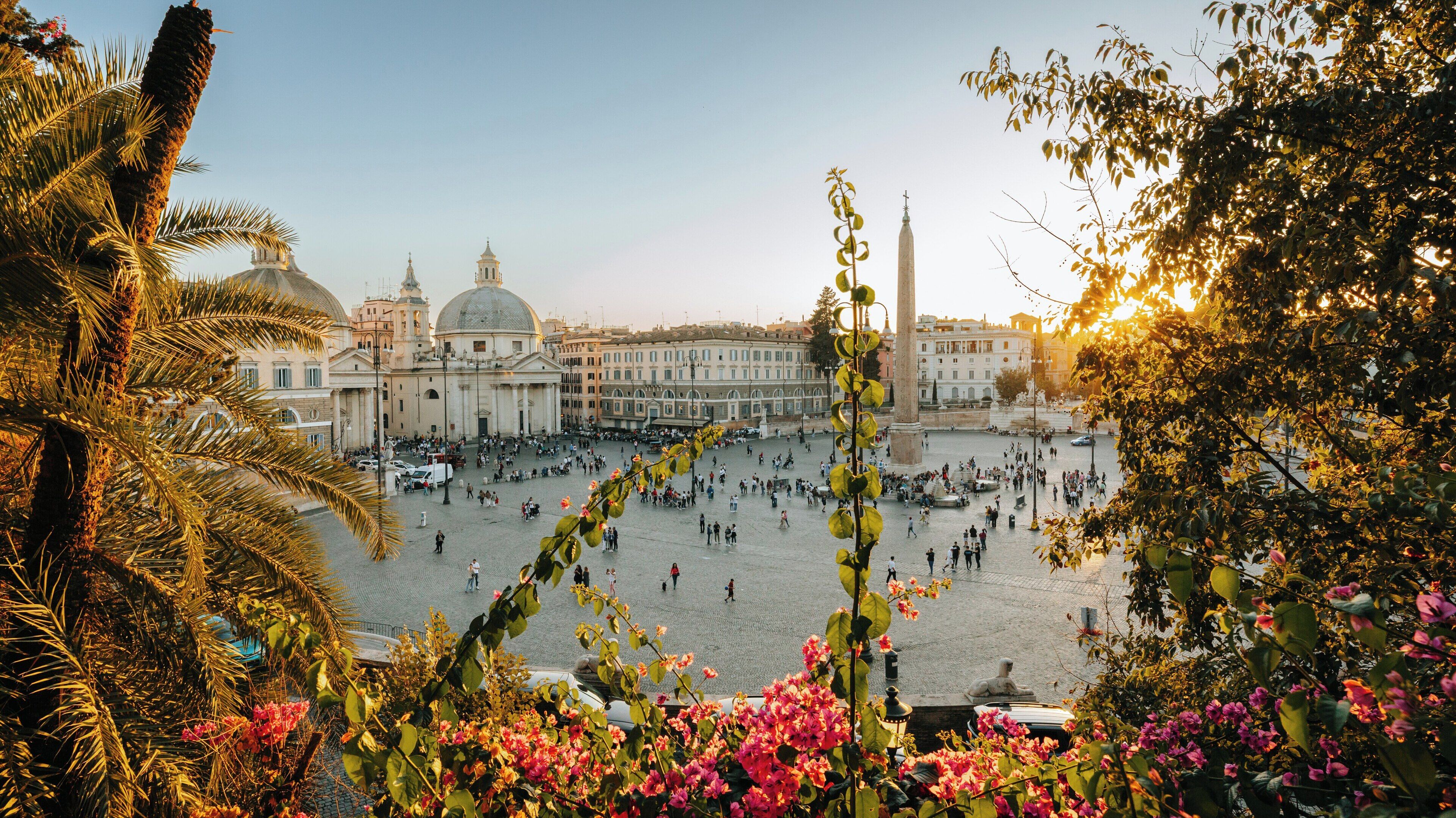 Stunning sunset view over Piazza del Popolo showcasing bustling crowds and vibrant flowers in the heart of Rome, Lazio
