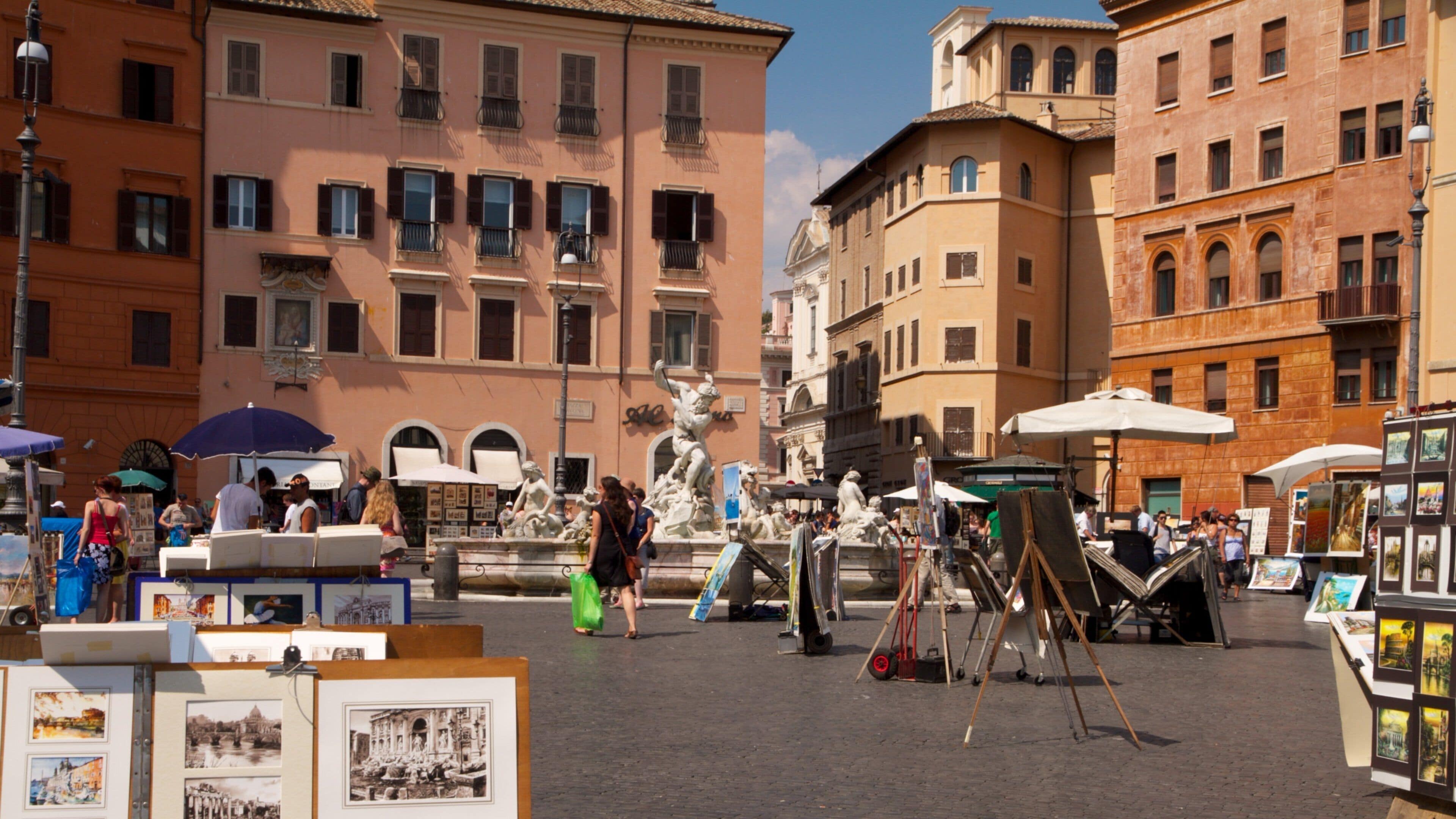 Explore the vibrant atmosphere of Piazza Navona in Rome, where artists display their works on a sunny day