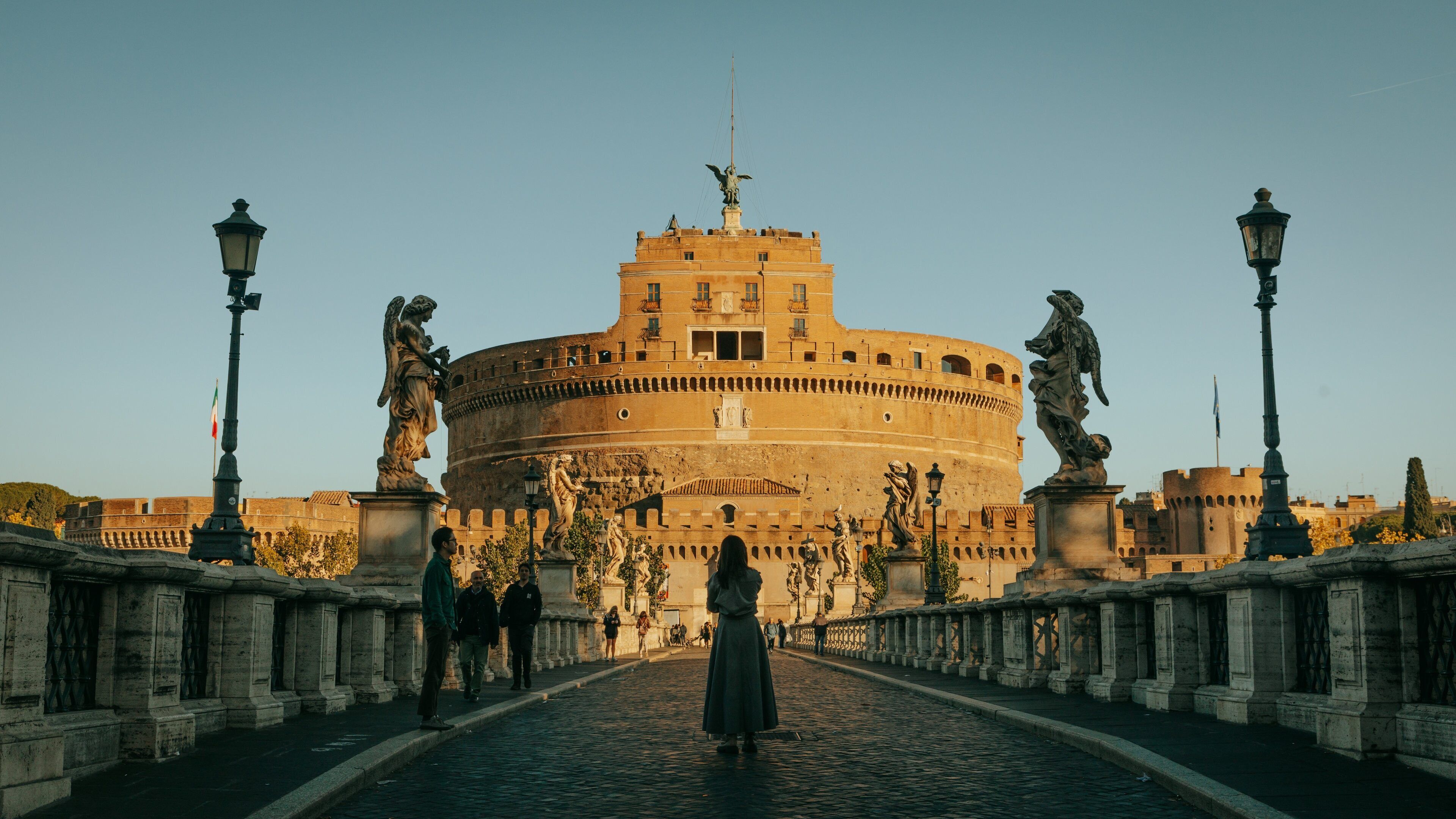 Ponte Sant\'Angelo which includes heritage architecture, a statue or sculpture and a sunset