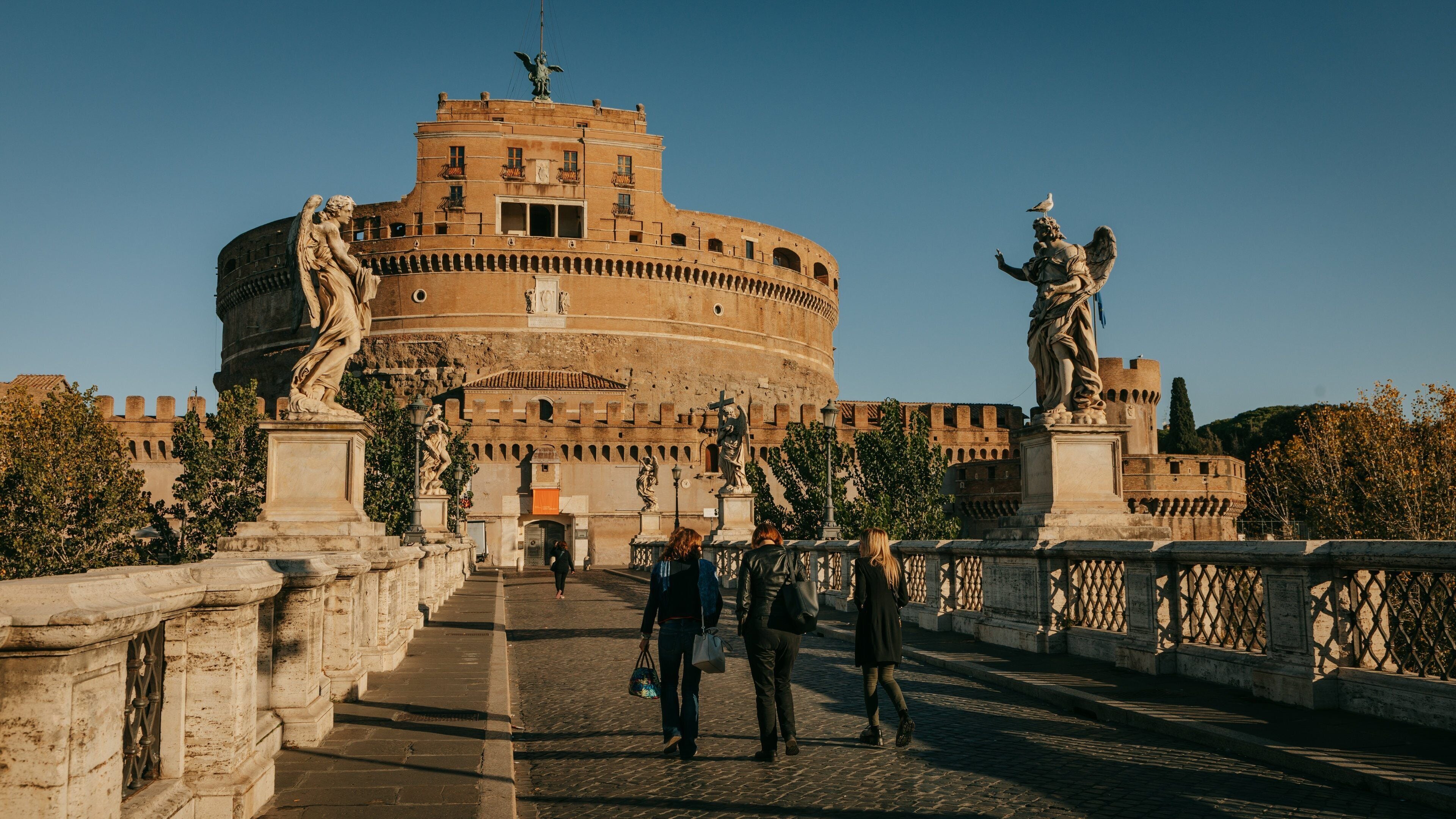 Ponte Sant\'Angelo showing a sunset, a statue or sculpture and heritage architecture