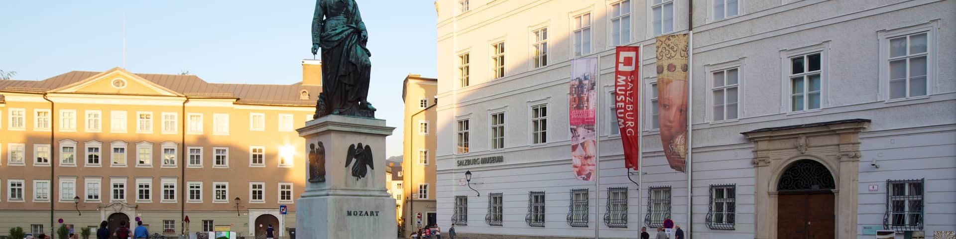 A statue in a square with a museum building in the background.