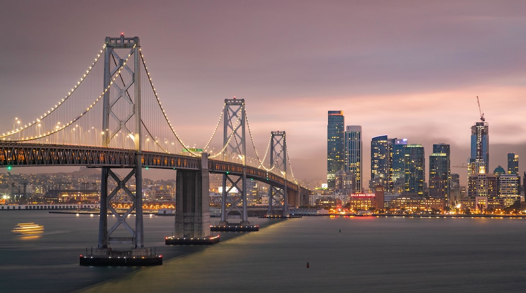 Bay Bridge which includes night scenes, a river or creek and a city