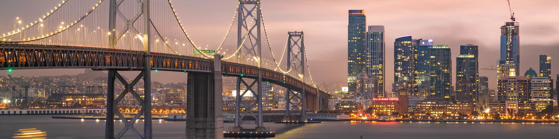 Bay Bridge which includes night scenes, a river or creek and a city