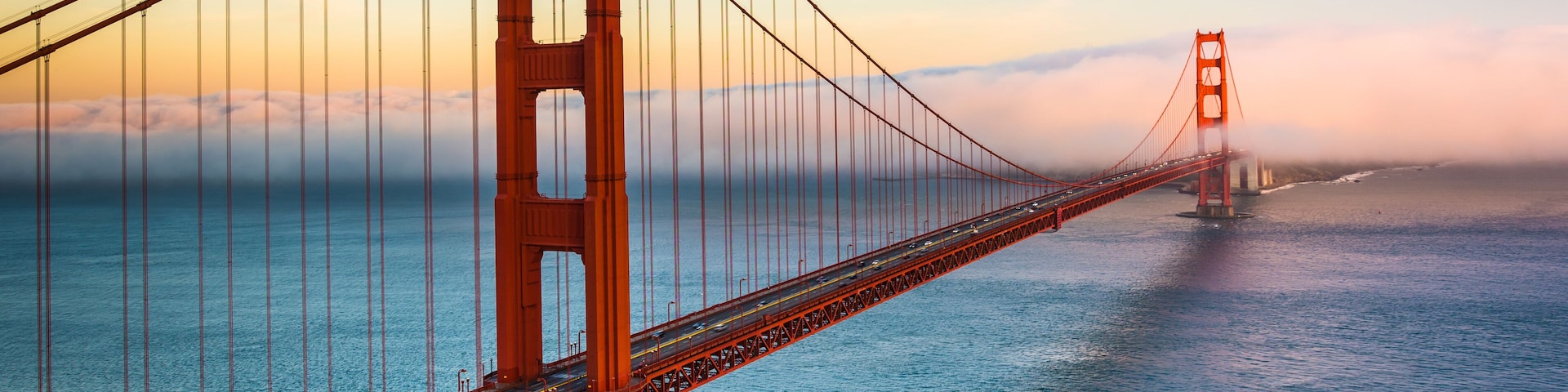The Golden Gate Bridge spanning the San Francisco Bay with a clear sky.