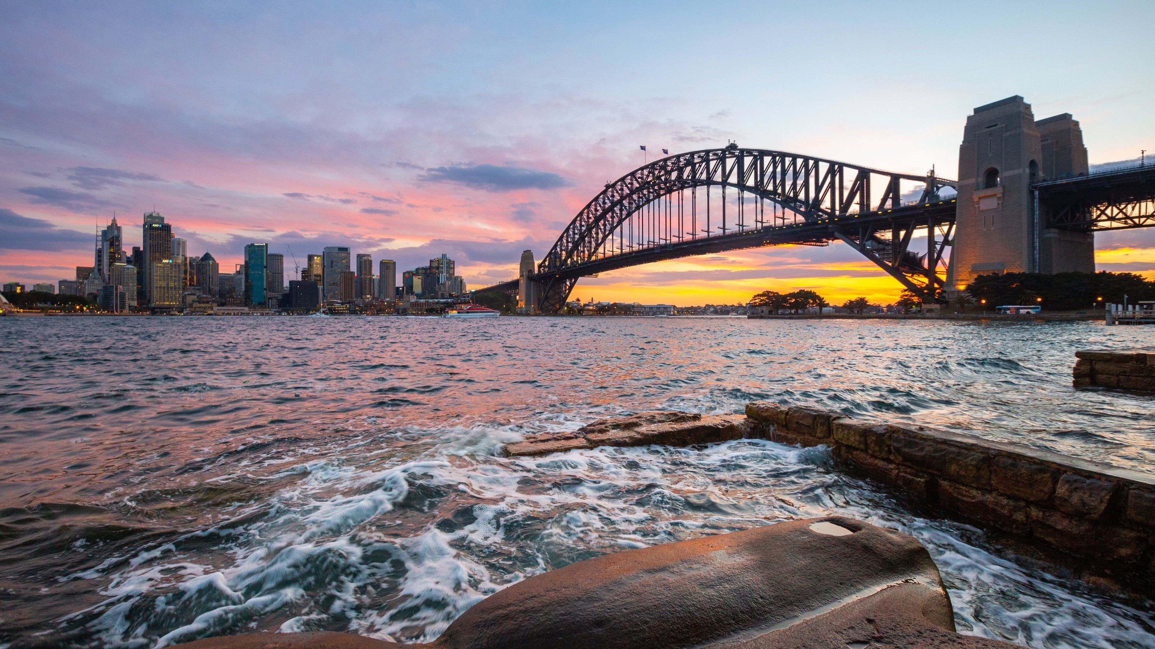 Sydney Harbour Bridge featuring a sunset, a city and a bay or harbor