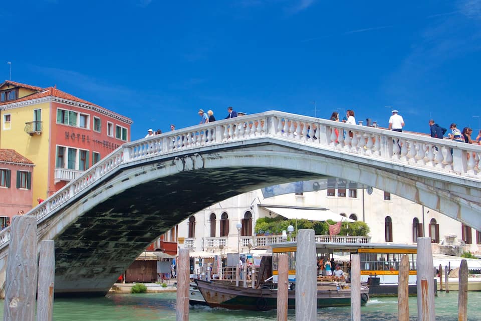 A stone bridge with people walking on it.
