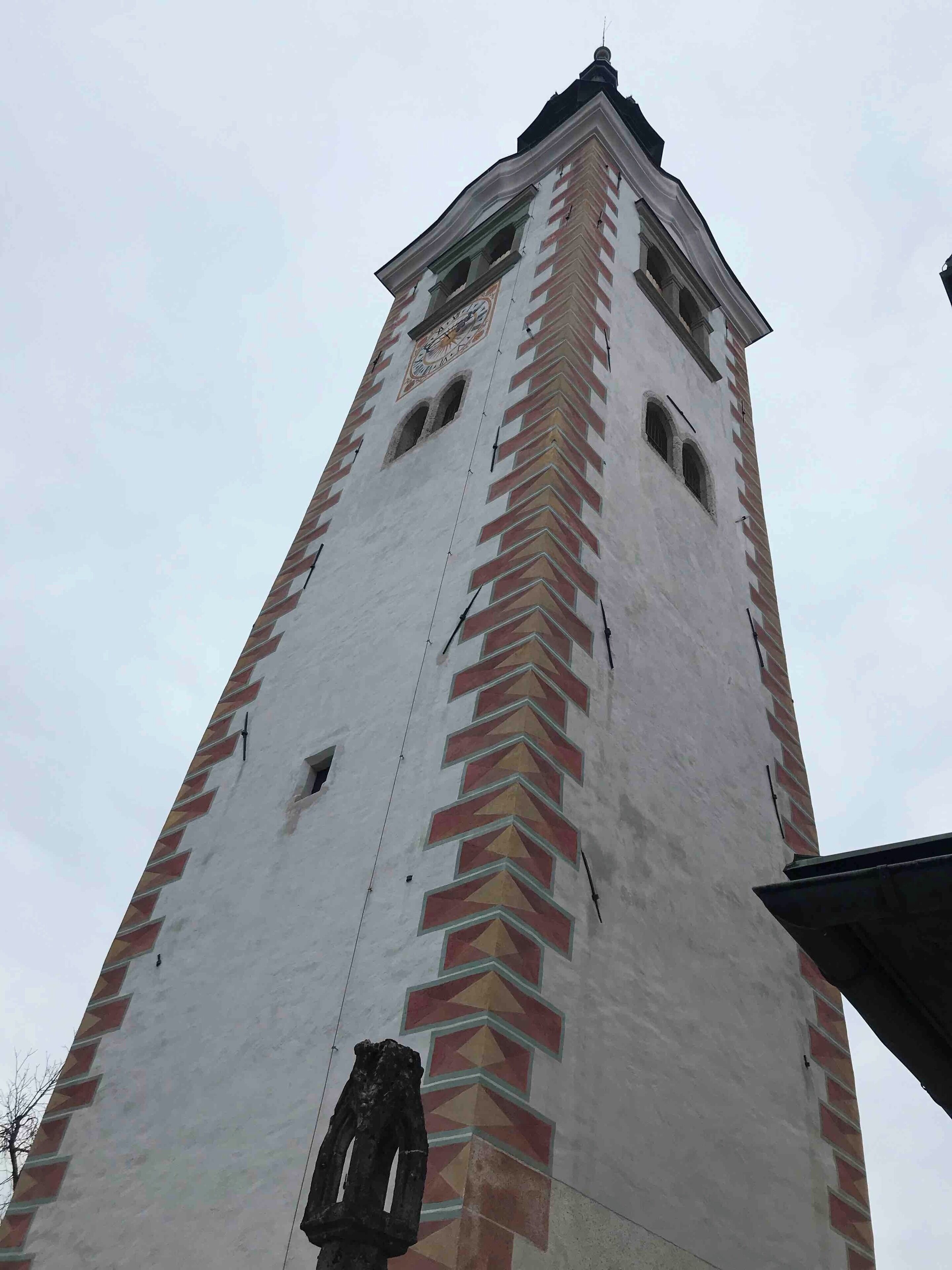 The tower of The Pilgrimage Church of the Assumption of Maria/Mary on Bled Island.  The church is reached by a short boat ride across Lake Bled costing 15EU for a return trip and climbing the 99 steps that lead up to it.  For 6EU you can enter the church and also climb the tower for a further fee. 
#LakeBled #Water #Slovenia #Reflections #Church #PilgrimageChurchOfTheAssumptionOfMaria #Architecture
