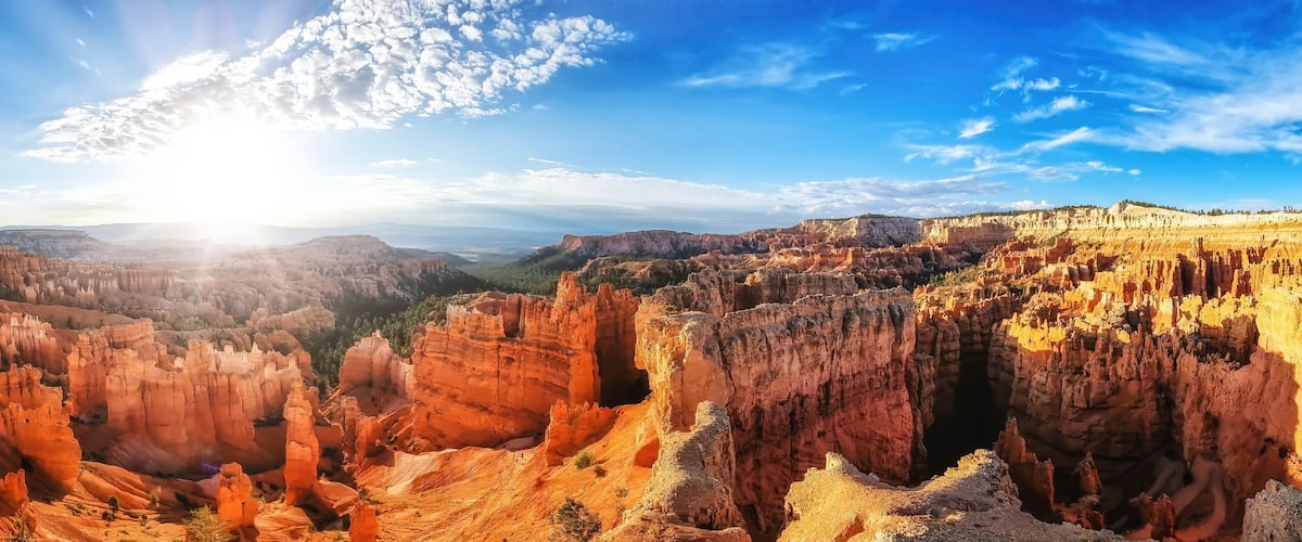 A canyon with layered rock formations and a clear sky.